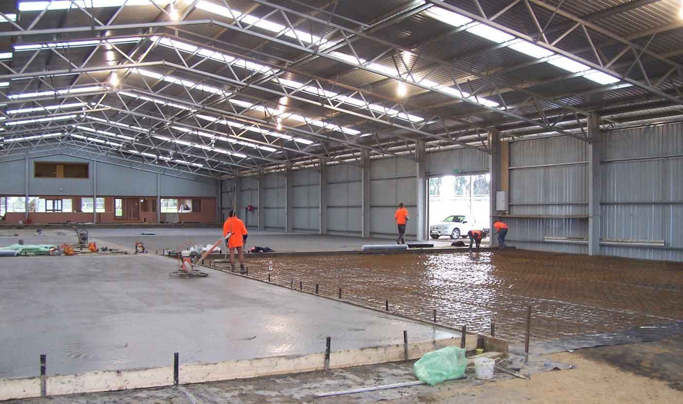 A large warehouse with a roof that has a lot of lights on it