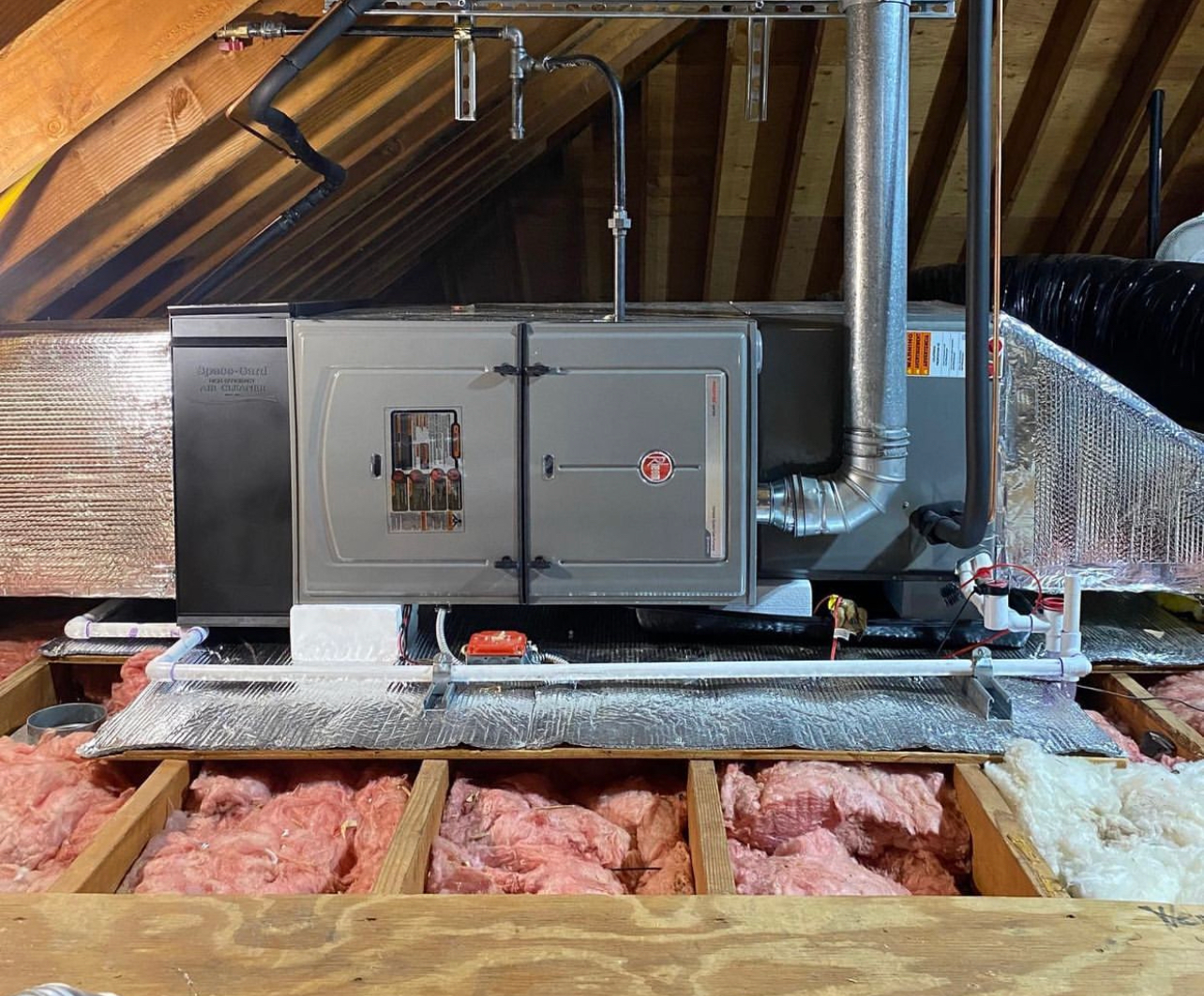 An air conditioner is installed in the attic of a house