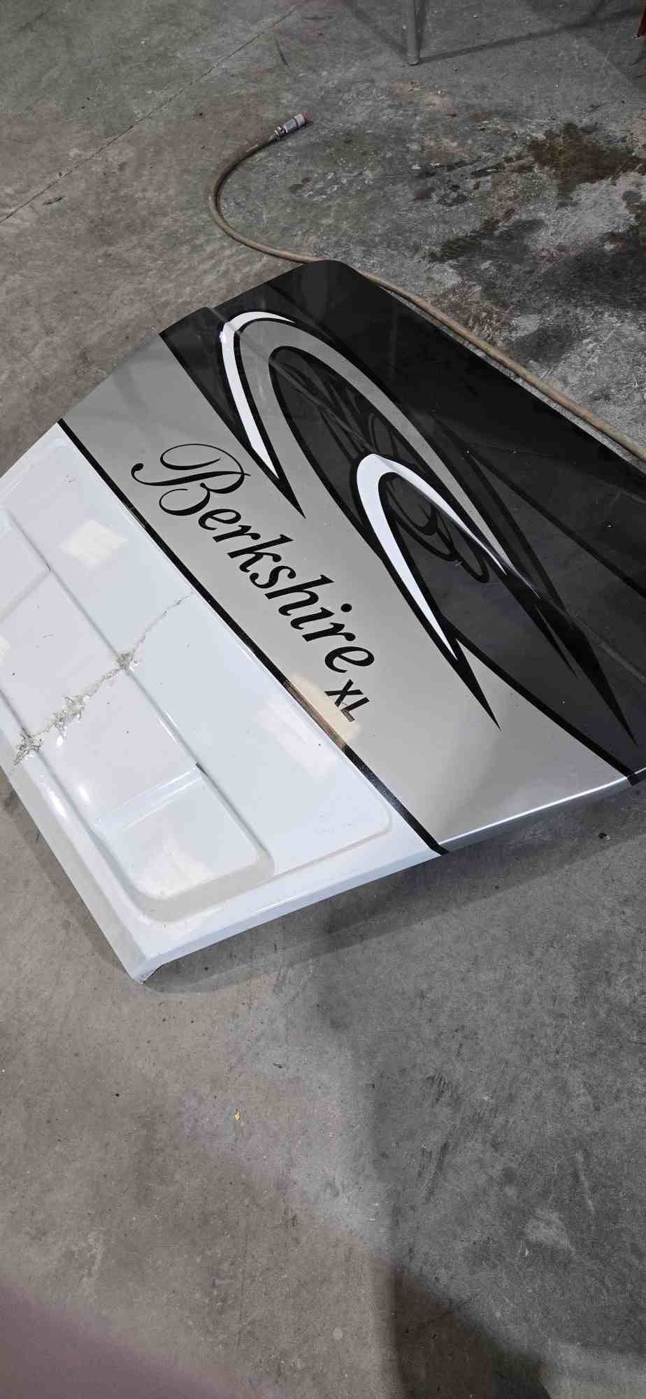 A Berkshire XL logo is on a white and silver panel, set on a gray surface.