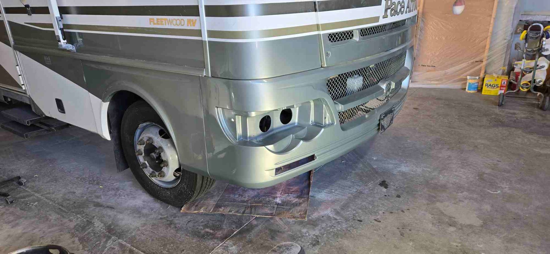 Bright, circular lights in a row, lit with orange handles and cords, against a dark backdrop.