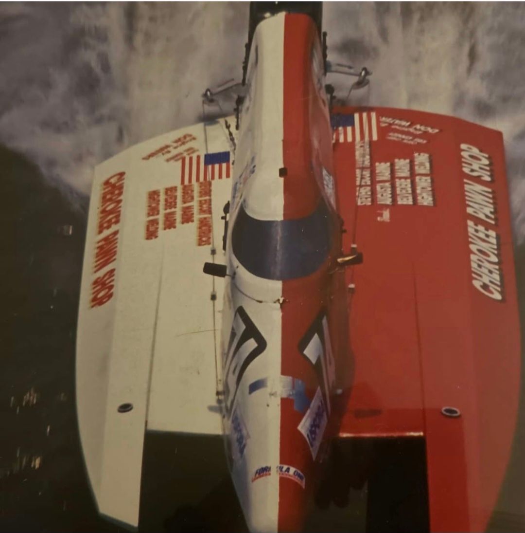 Red and white racing boat, overhead view. 