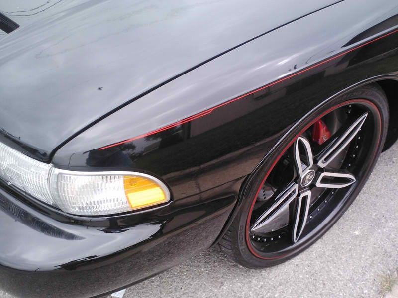 A black car with a red stripe on the side