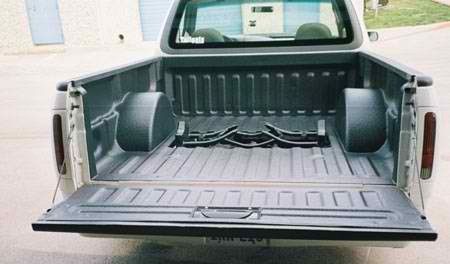 The back of a pickup truck with the bed open.