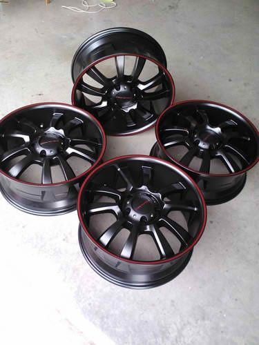 A bunch of metal gears and bearings are laying on a table.