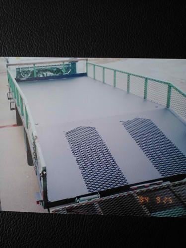 A picture of a truck with a ramp on the back of it.