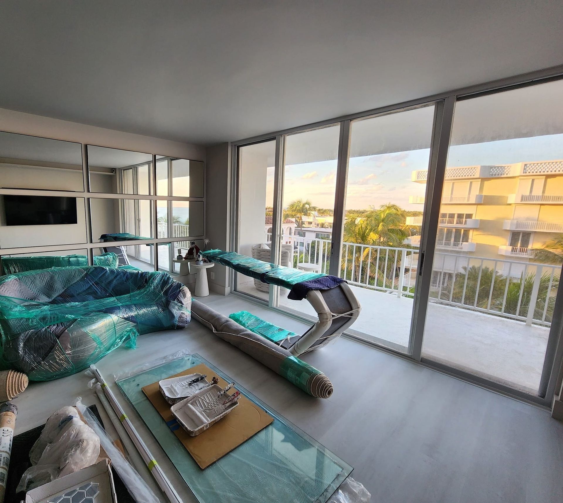 A living room with a treadmill and a large window