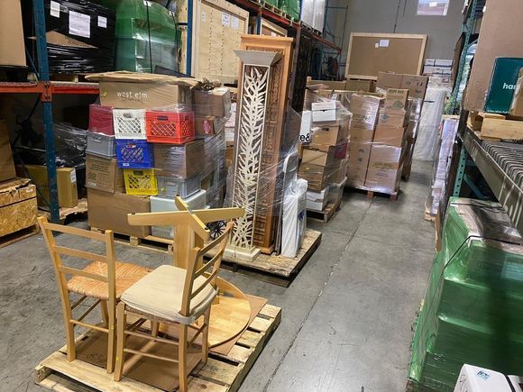 A warehouse filled with lots of boxes and chairs.