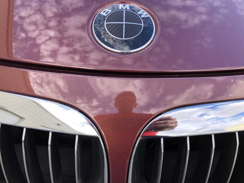 A close up of a bmw emblem on the hood of a car