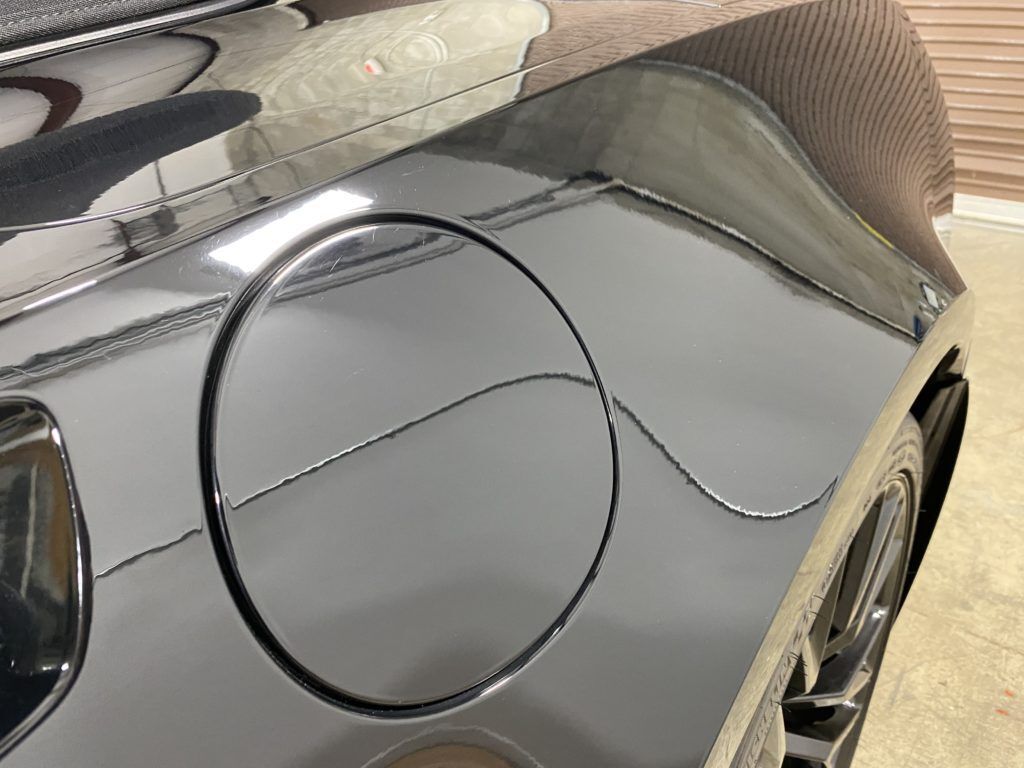 A black car with a circle on the side of it.