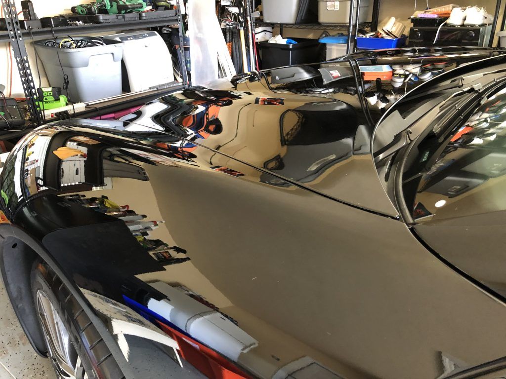 A black car is parked in a garage.