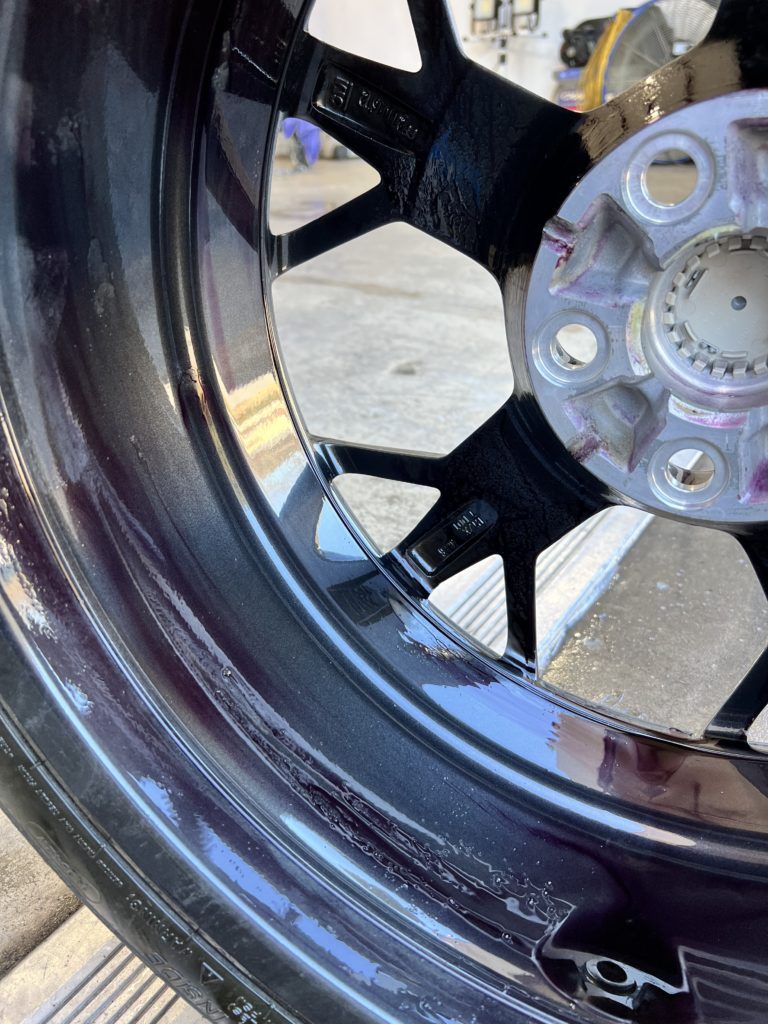 A close up of a black wheel on a car.
