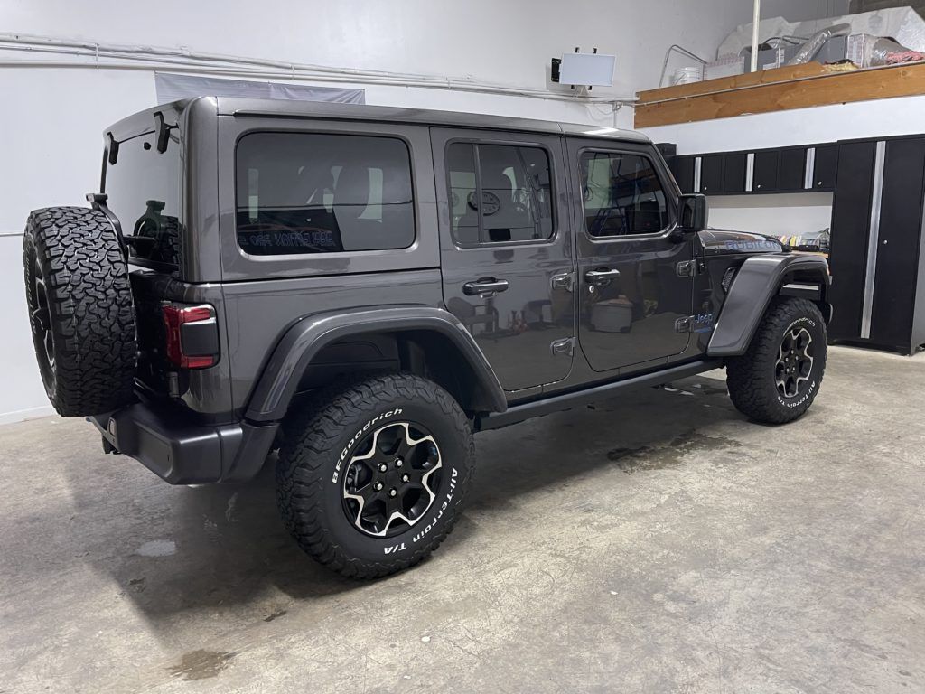 A jeep wrangler is parked in a garage.