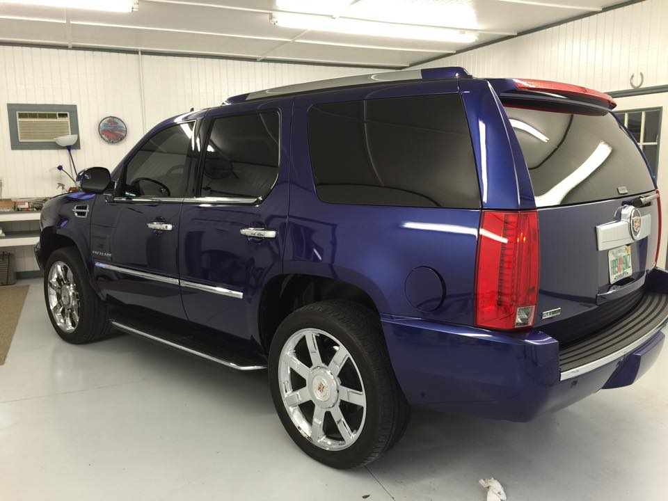 A blue suv is parked in a garage.