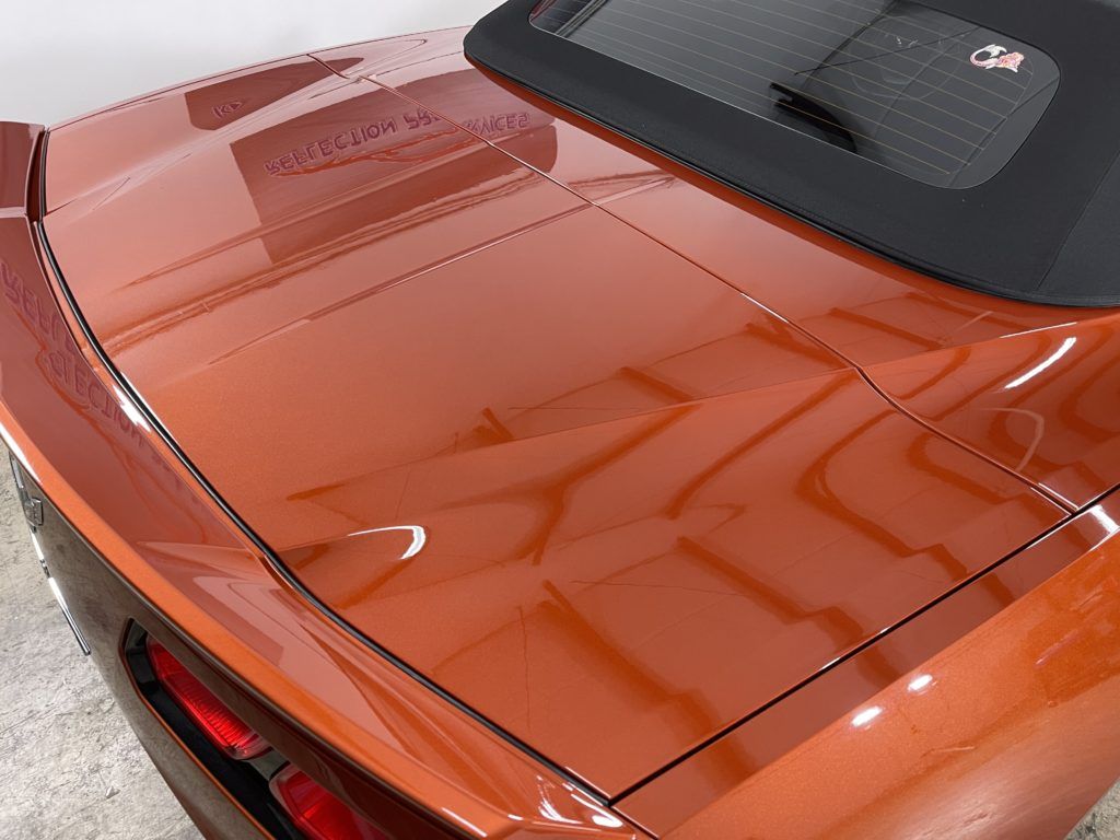 A close up of the trunk of an orange car