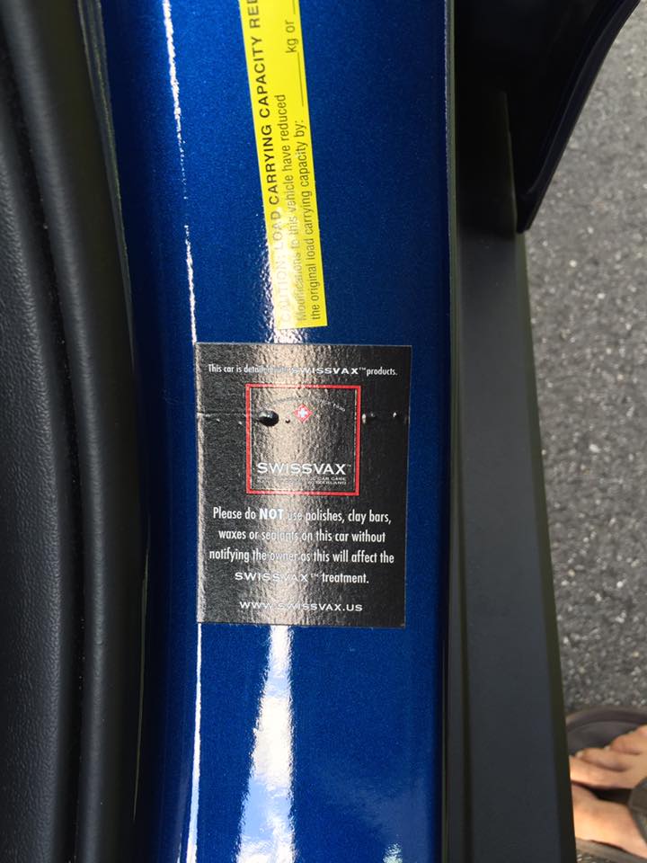 A blue car has a sticker on the side that says certified capacity