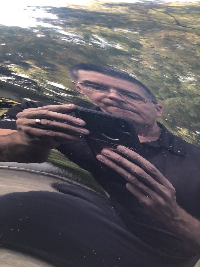 A man is taking a picture of himself in a mirror.