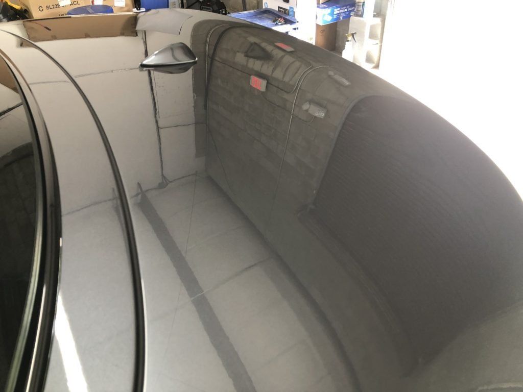 A gray couch is sitting in the back of a car