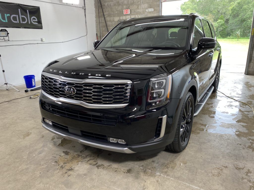 A black suv is parked in a garage.