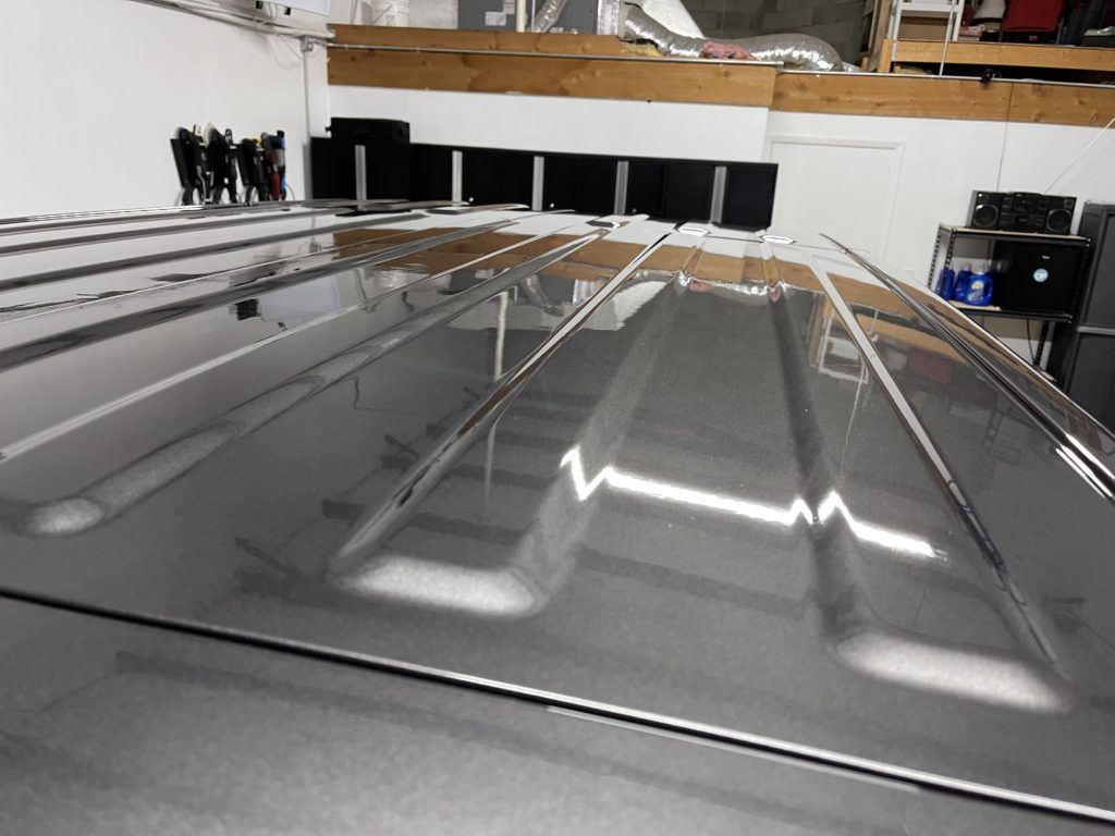 The roof of a car is reflected in the floor