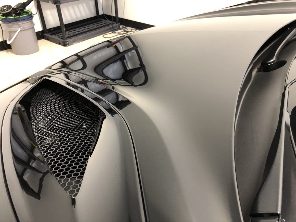 A close up of the hood of a car.