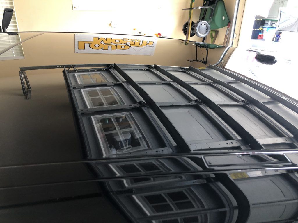 A garage door with a sign on the wall that says repair