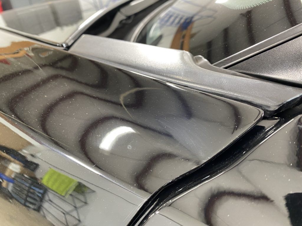 A close up of a car 's hood and windshield.