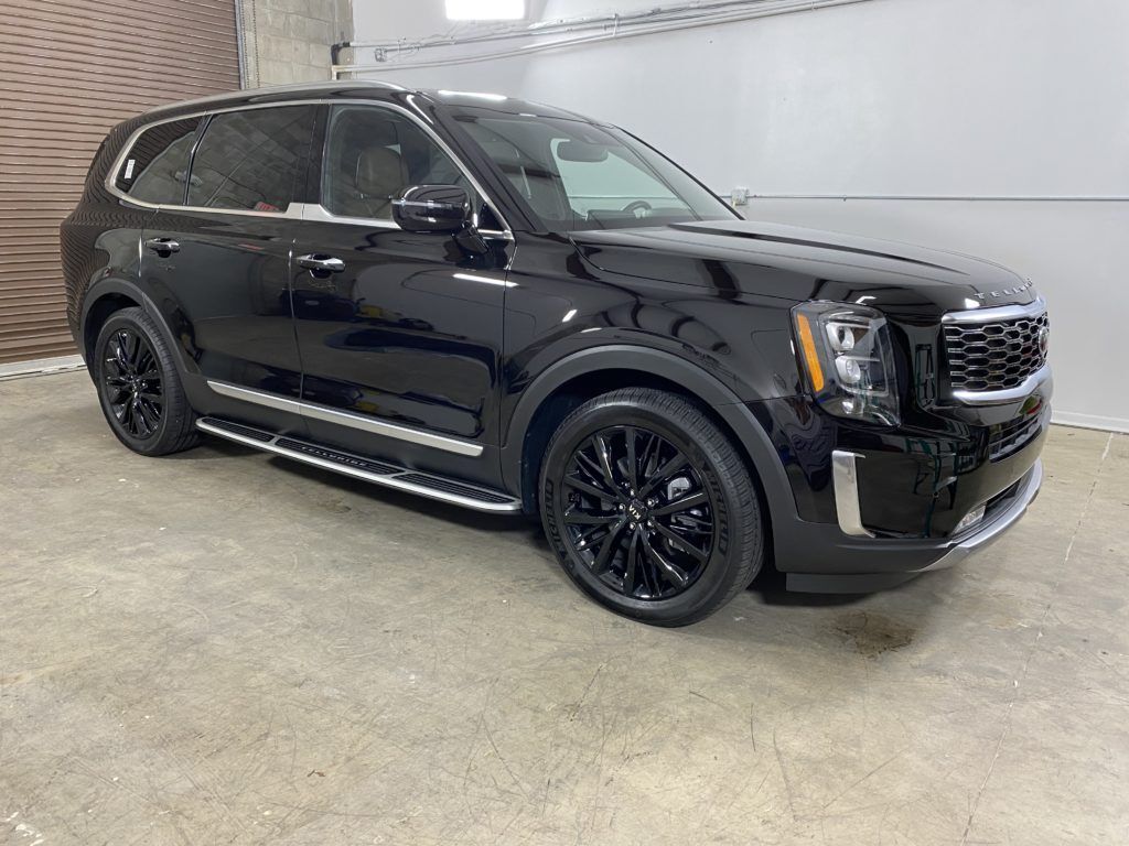 A black suv is parked in a garage.
