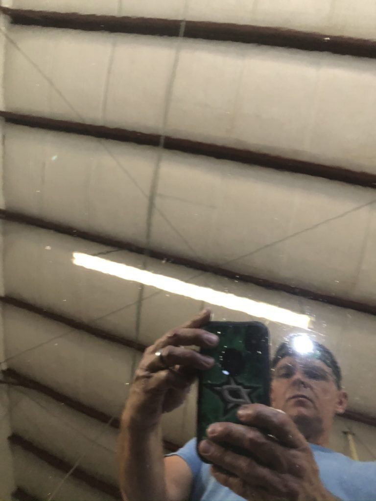 A man is taking a picture of himself in a mirror.