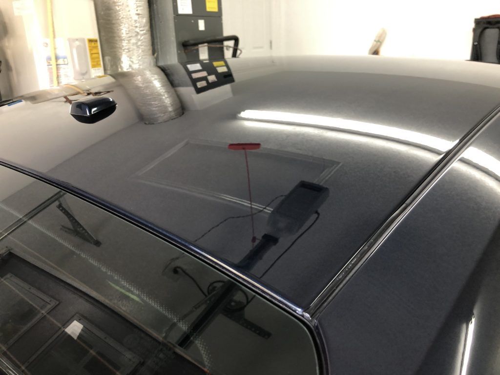 A close up of a car 's roof in a garage