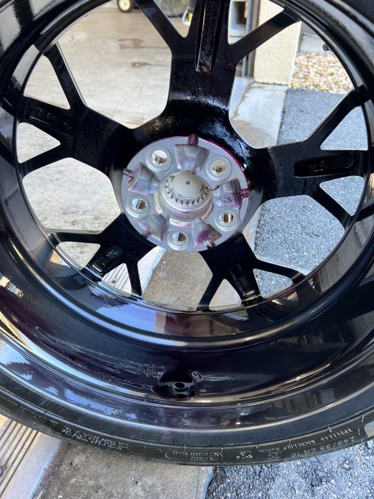 A close up of a black wheel with a tire on it.