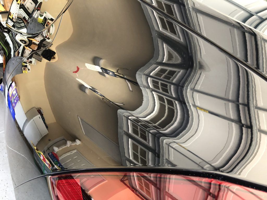 A reflection of a person in a mirror of a building.