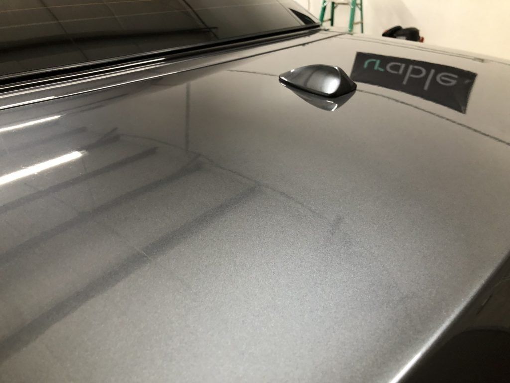 A close up of a car hood with a sticker on it that says napa