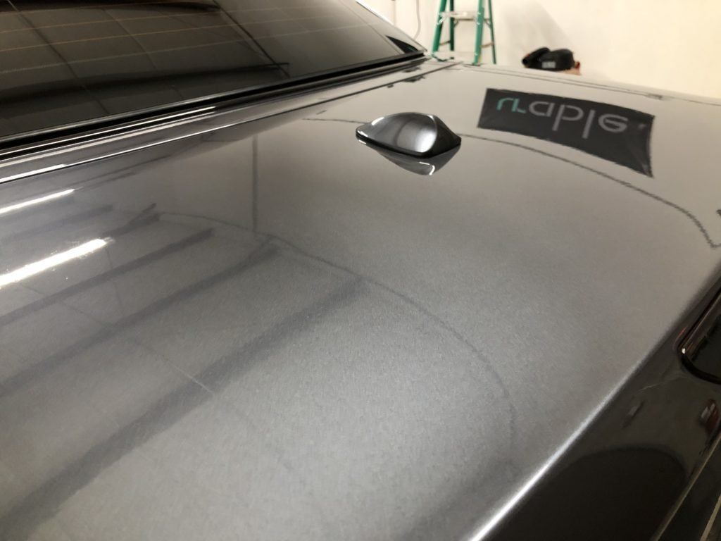 A close up of the hood of a black car