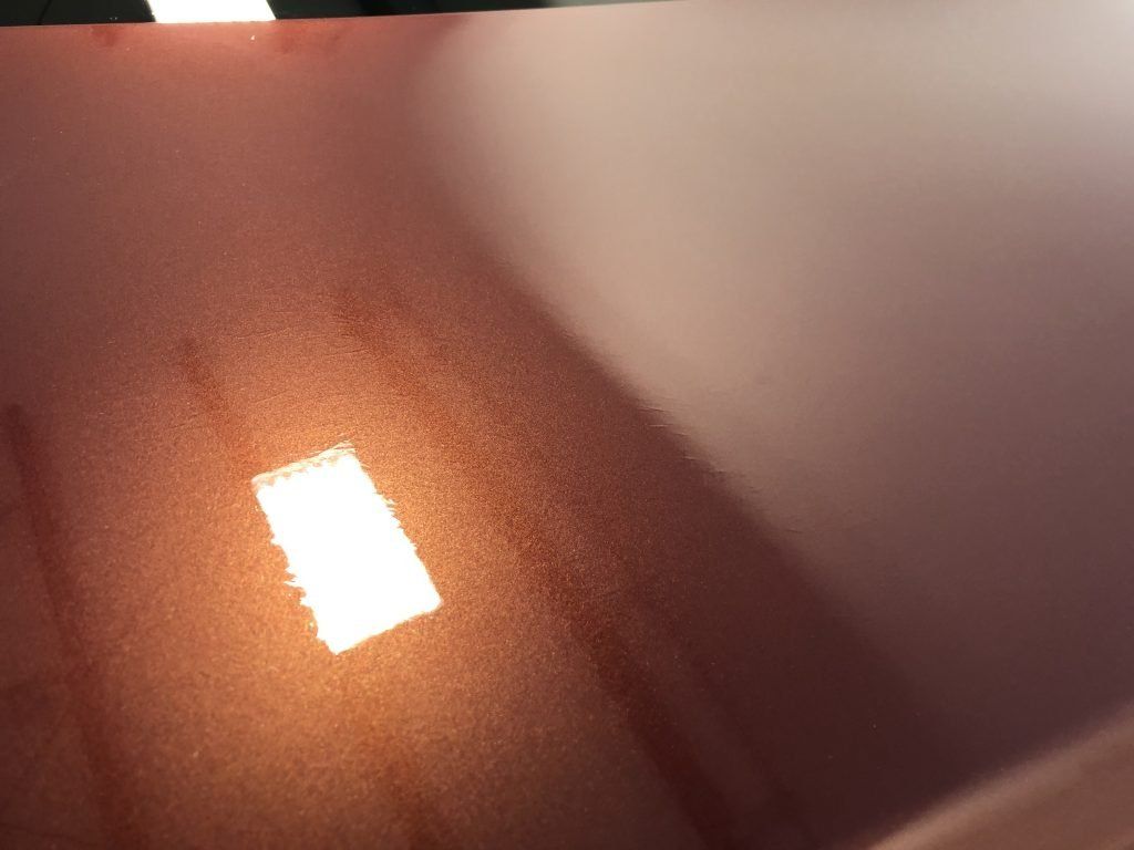 A close up of a red surface with a light shining on it
