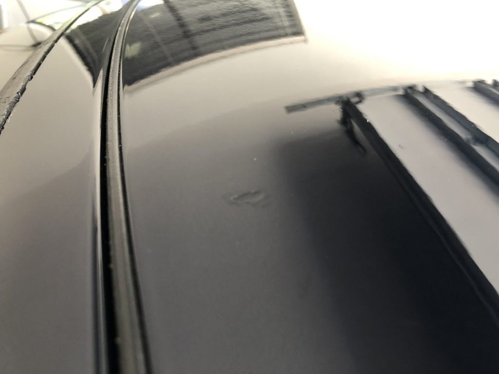 A close up of a car 's roof in a garage.