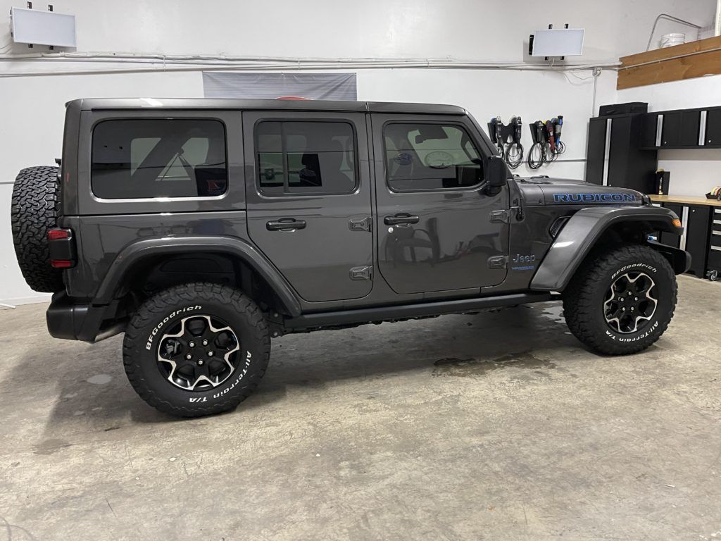A jeep wrangler is parked in a garage.