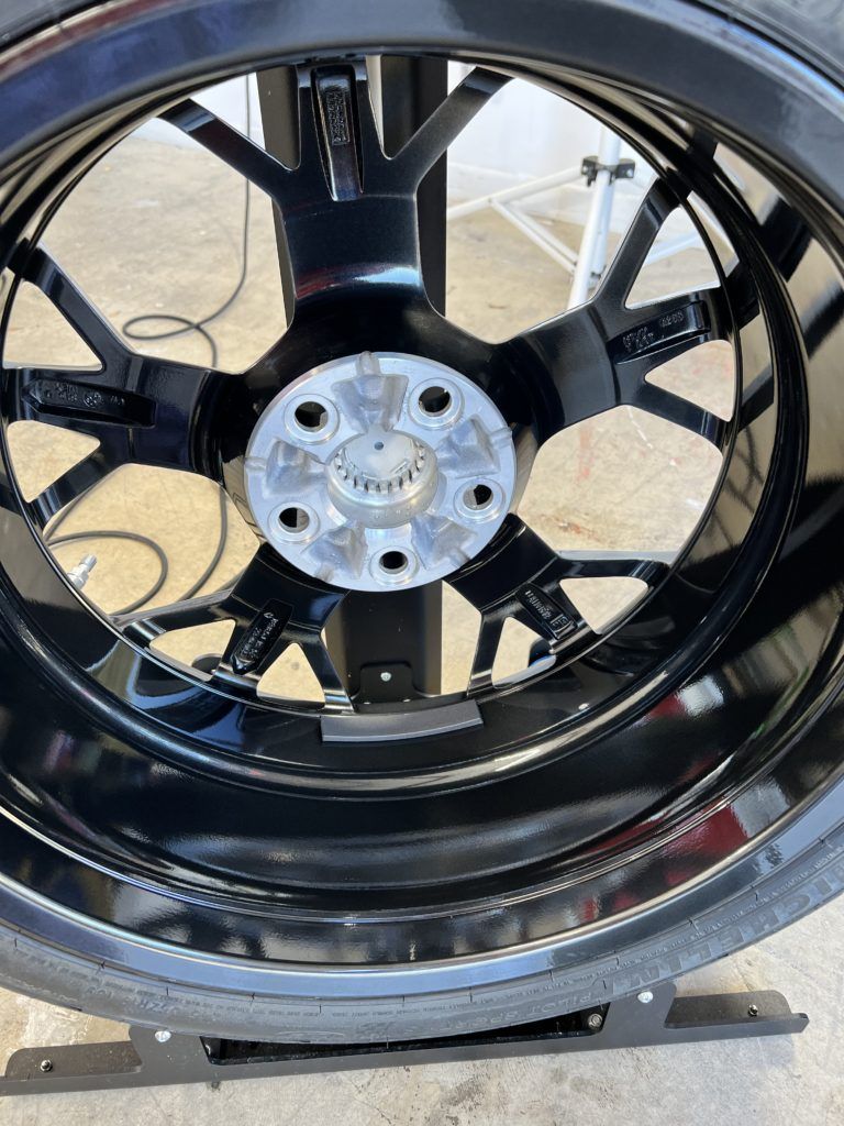 A close up of a car wheel on a stand