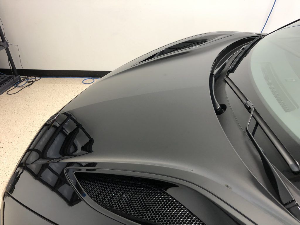 A close up of the hood of a black car