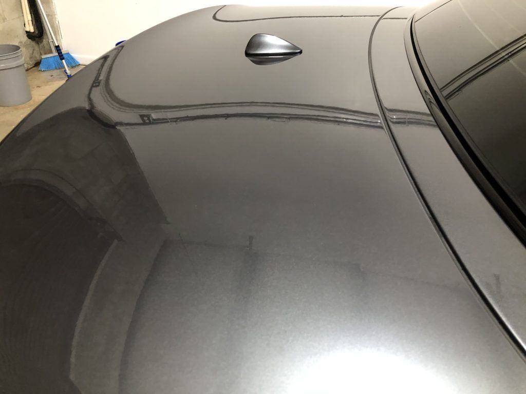 A close up of the hood of a car in a garage.