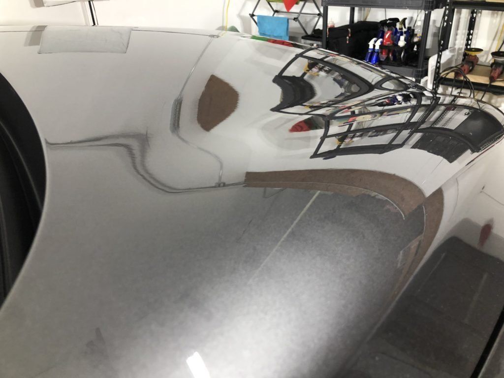 A close up of a car hood in a garage