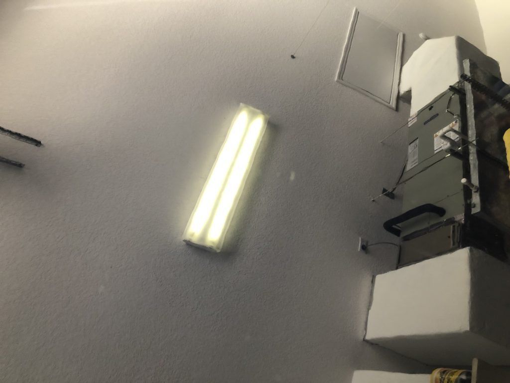 A white wall with a light on it