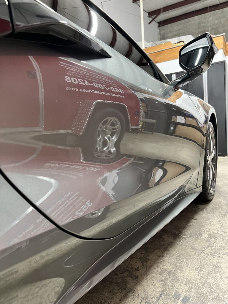 A close up of a car parked in a garage.