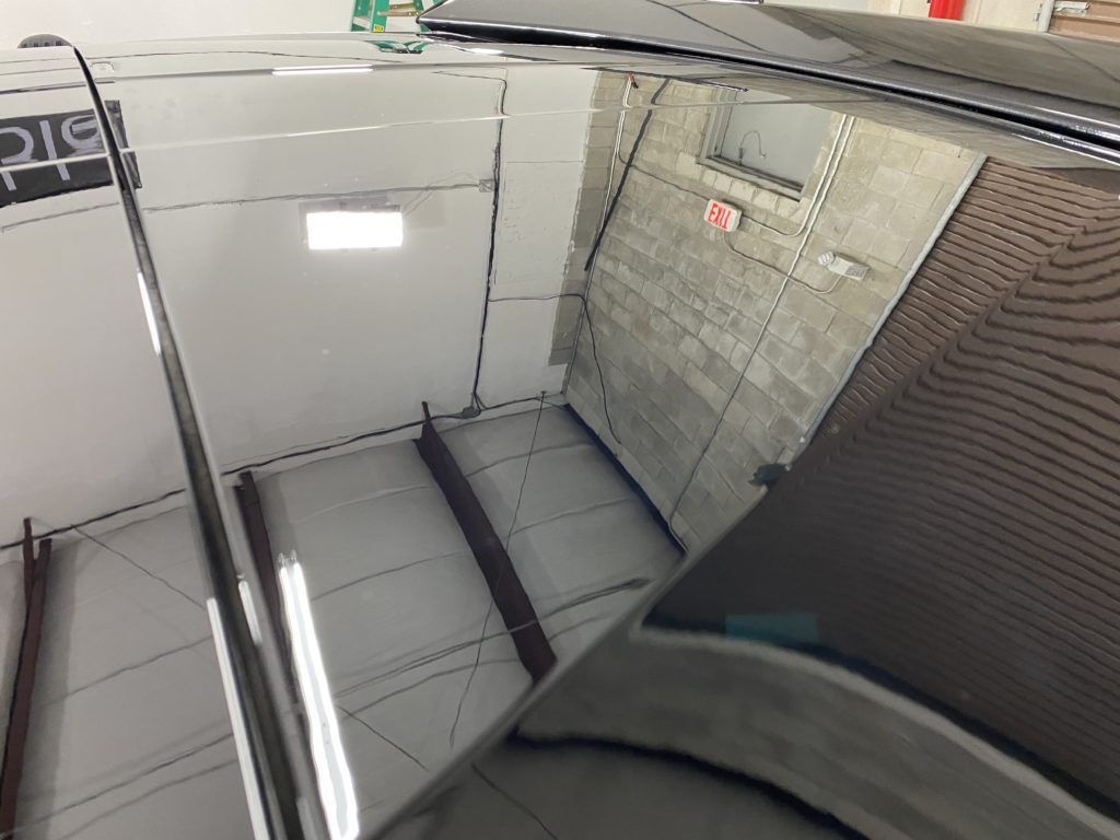 A reflection of a car in a mirror in a room