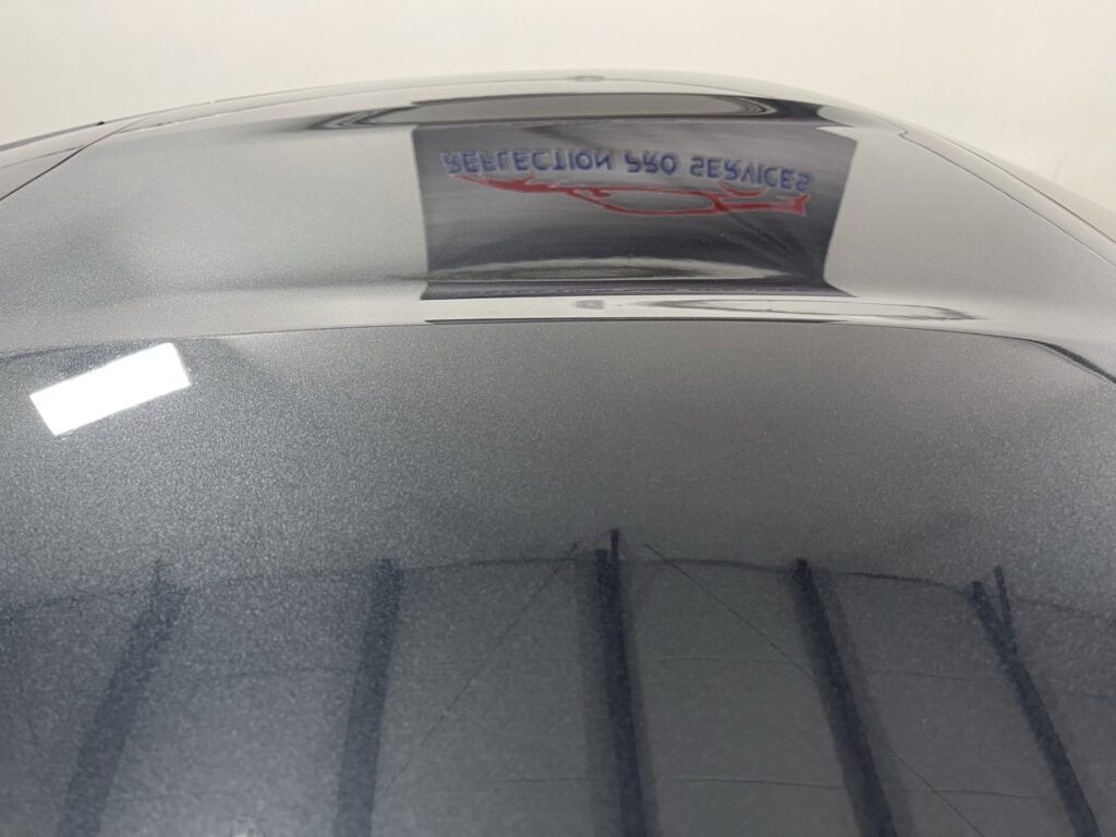 A close up of a car hood with a sticker on it