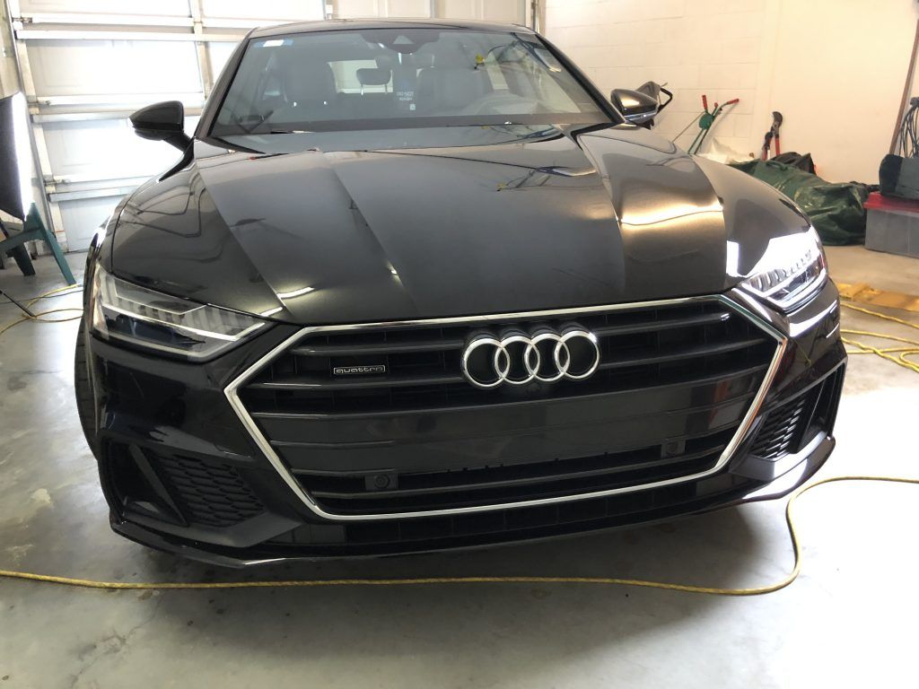 A black audi a7 is parked in a garage