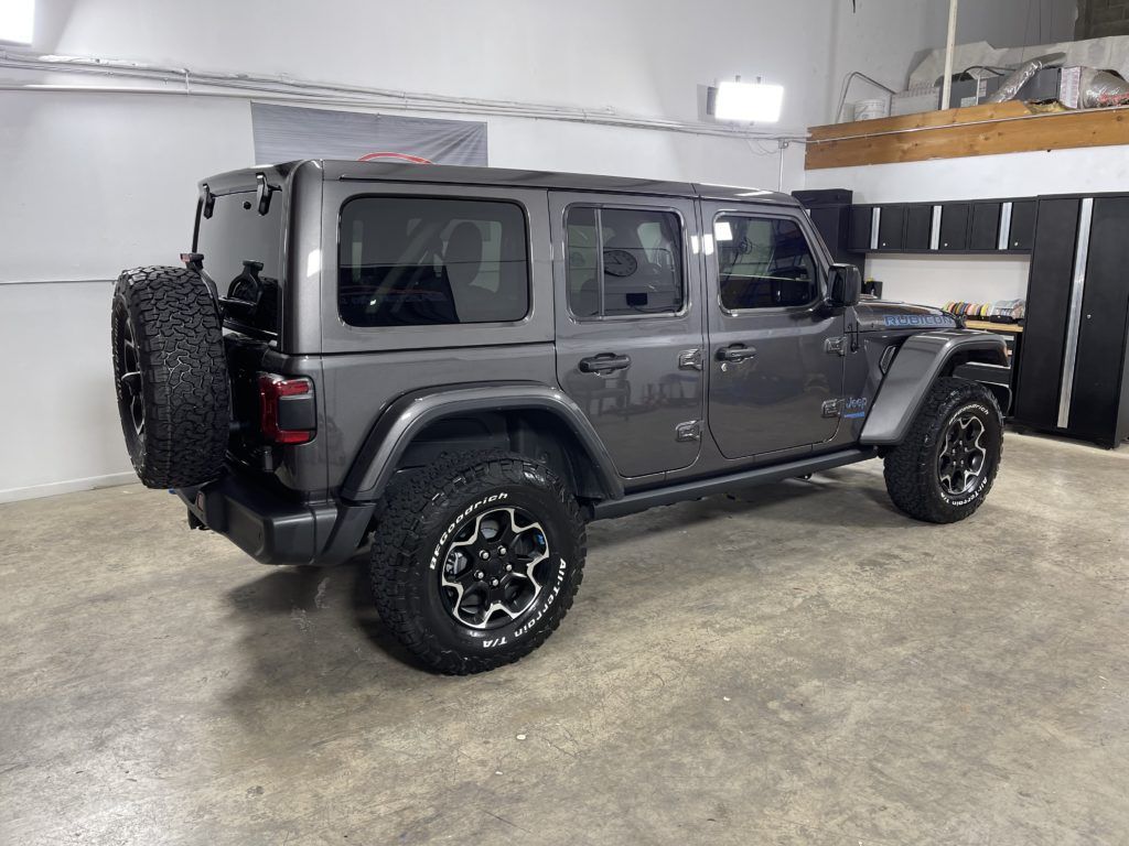 A jeep wrangler is parked in a garage.