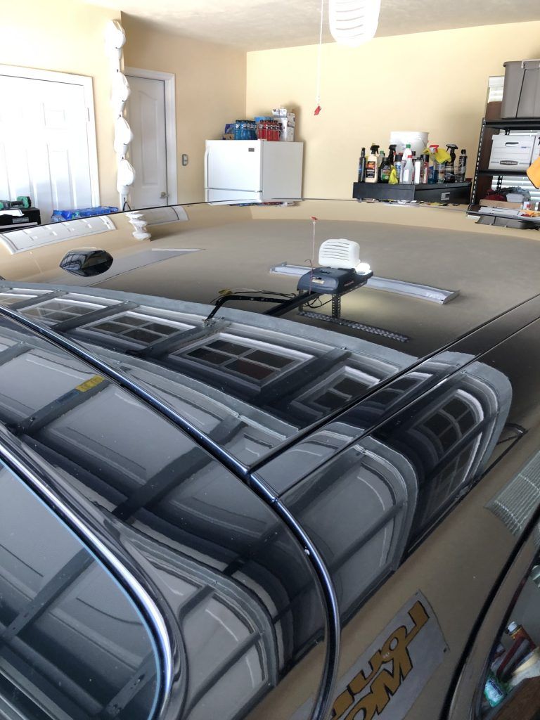 A purple truck is parked in a garage