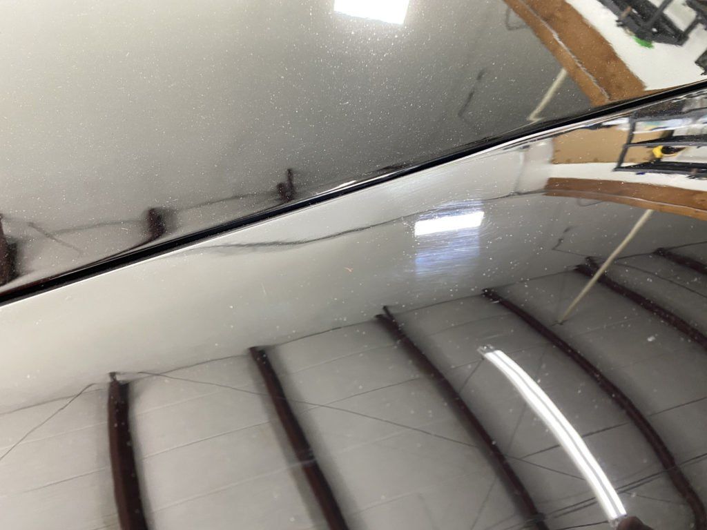 A close up of a car windshield in a garage.