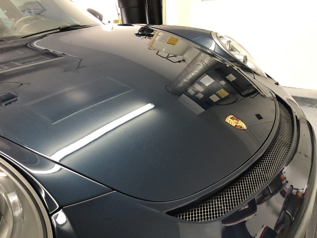 A close up of the hood of a porsche car