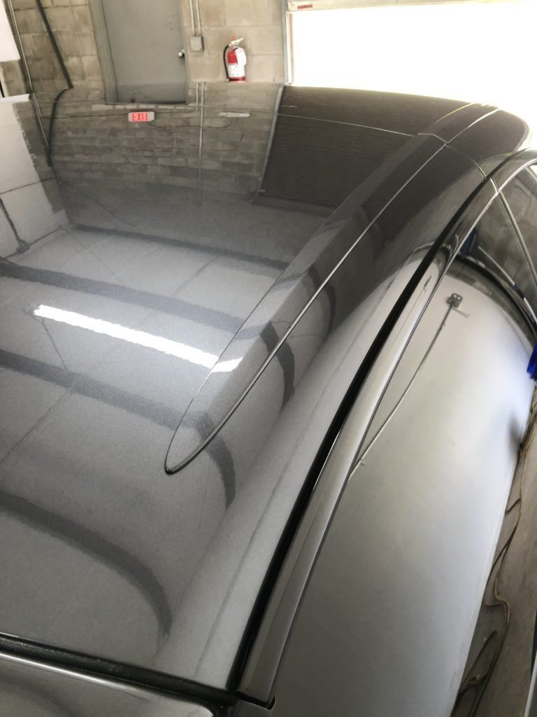 A close up of the roof of a car in a garage.